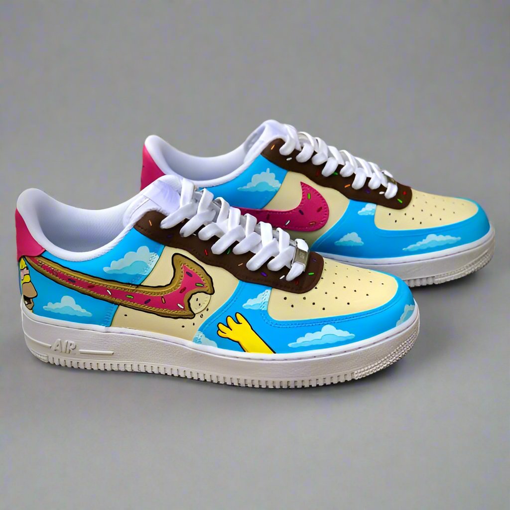 Custom Air Force 1 sneakers with cartoon-inspired donut and sky artwork on a grey background