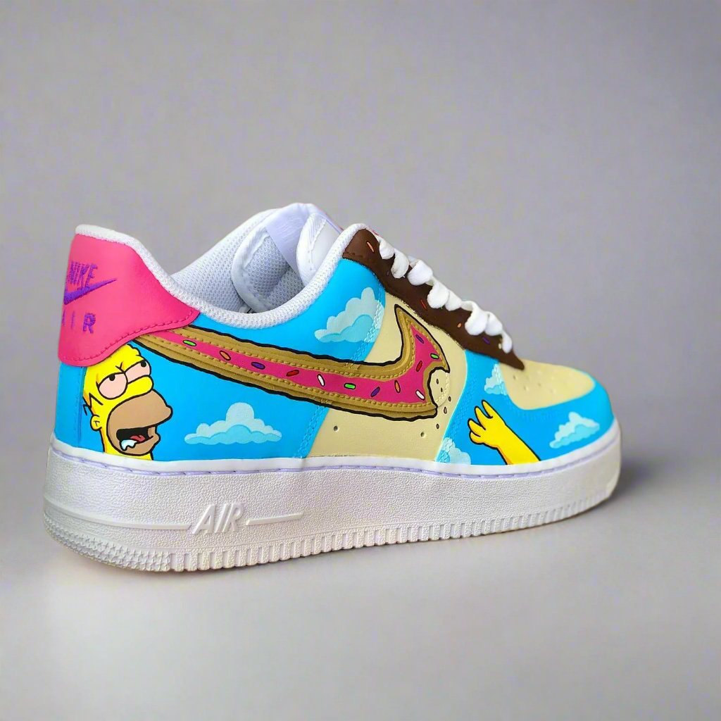 Custom Air Force 1 sneaker with cartoon-inspired donut and character artwork on blue sky background