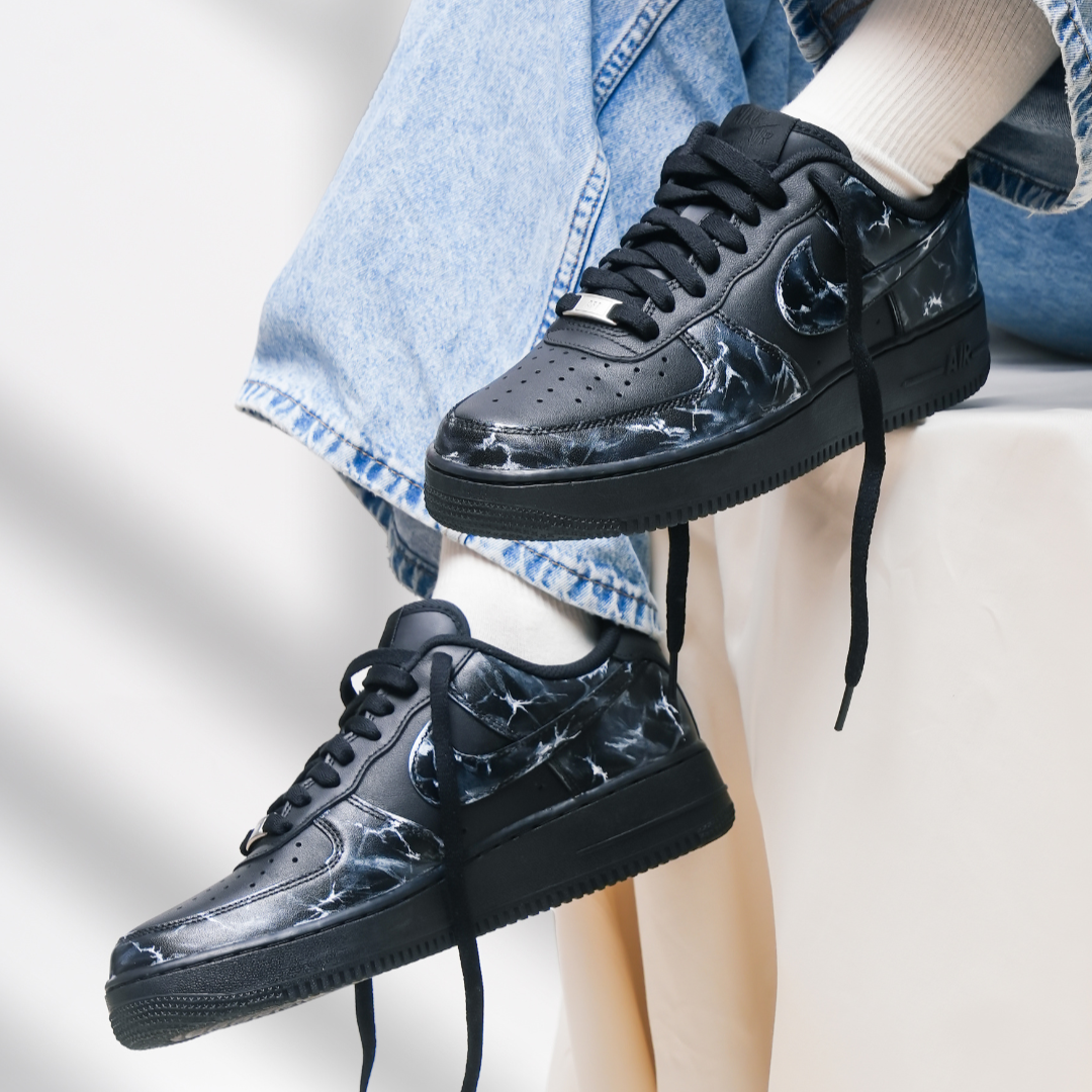 Black marble-pattern streetwear sneakers with white socks and light-wash jeans