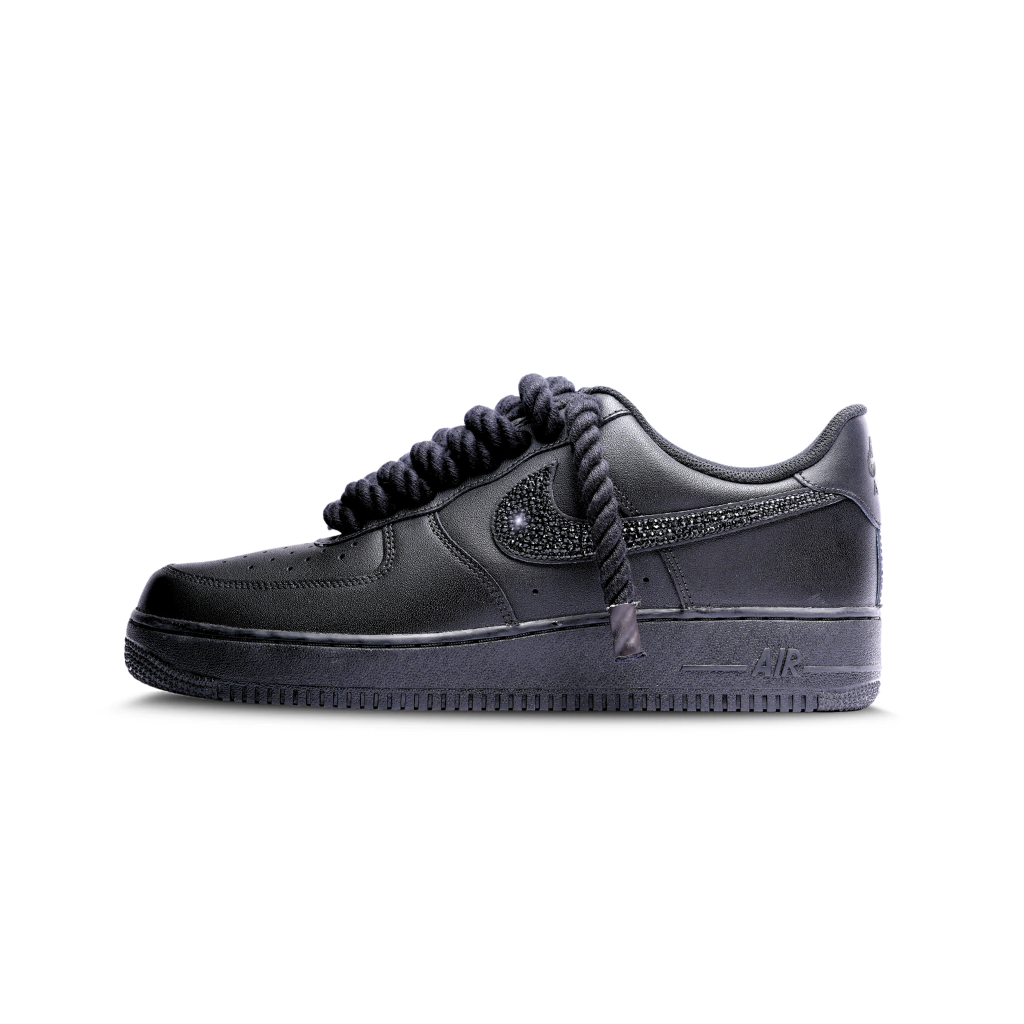 Black luxury sneaker with thick laces and embellished Swoosh on white background