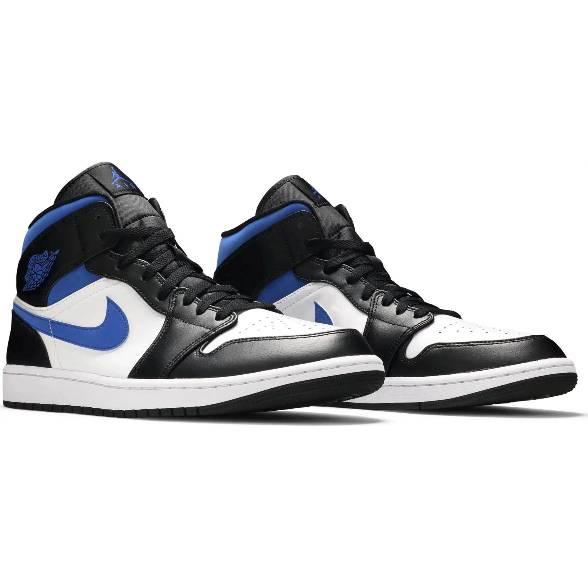 Black, white, and blue mid-top sneakers with perforated toe and blue Nike swoosh on white background