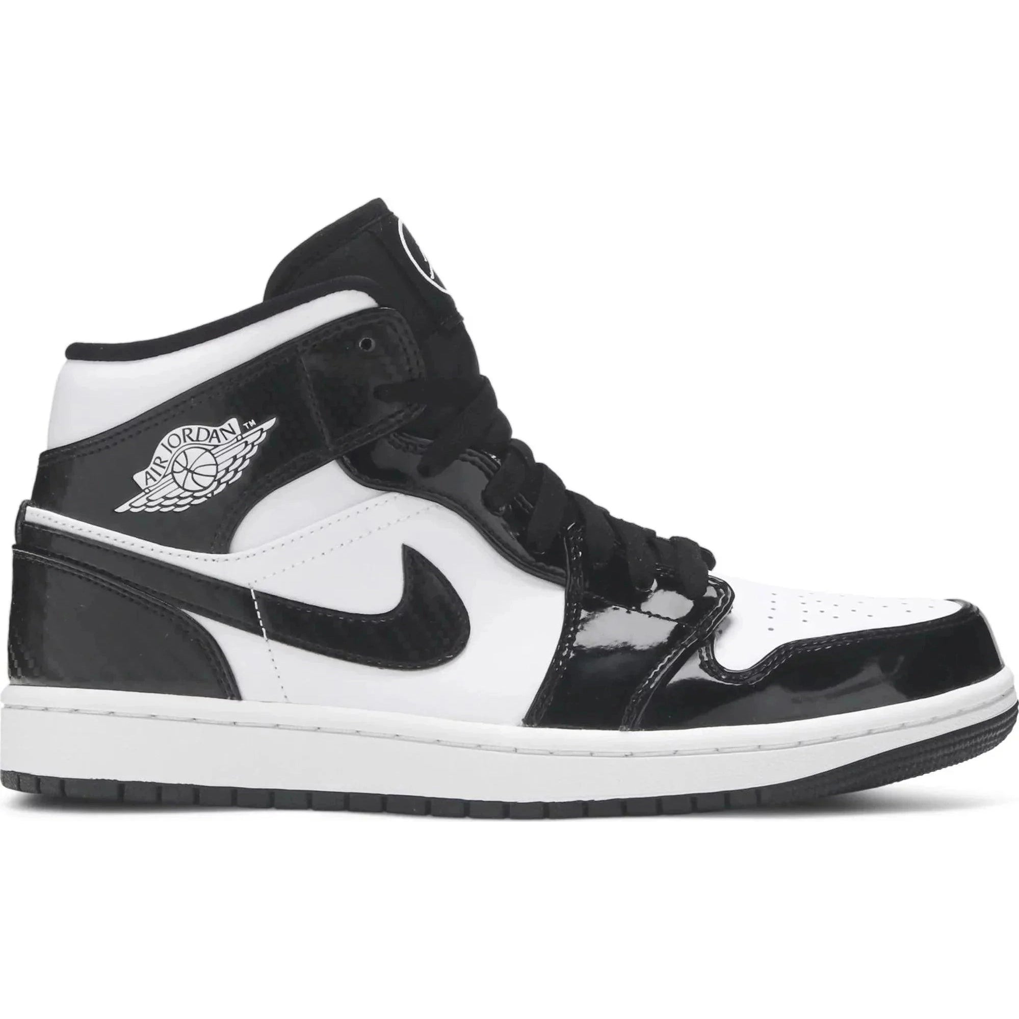 Black and white mid-top sneaker with leather panels, Air Jordan logo, and Nike Swoosh.