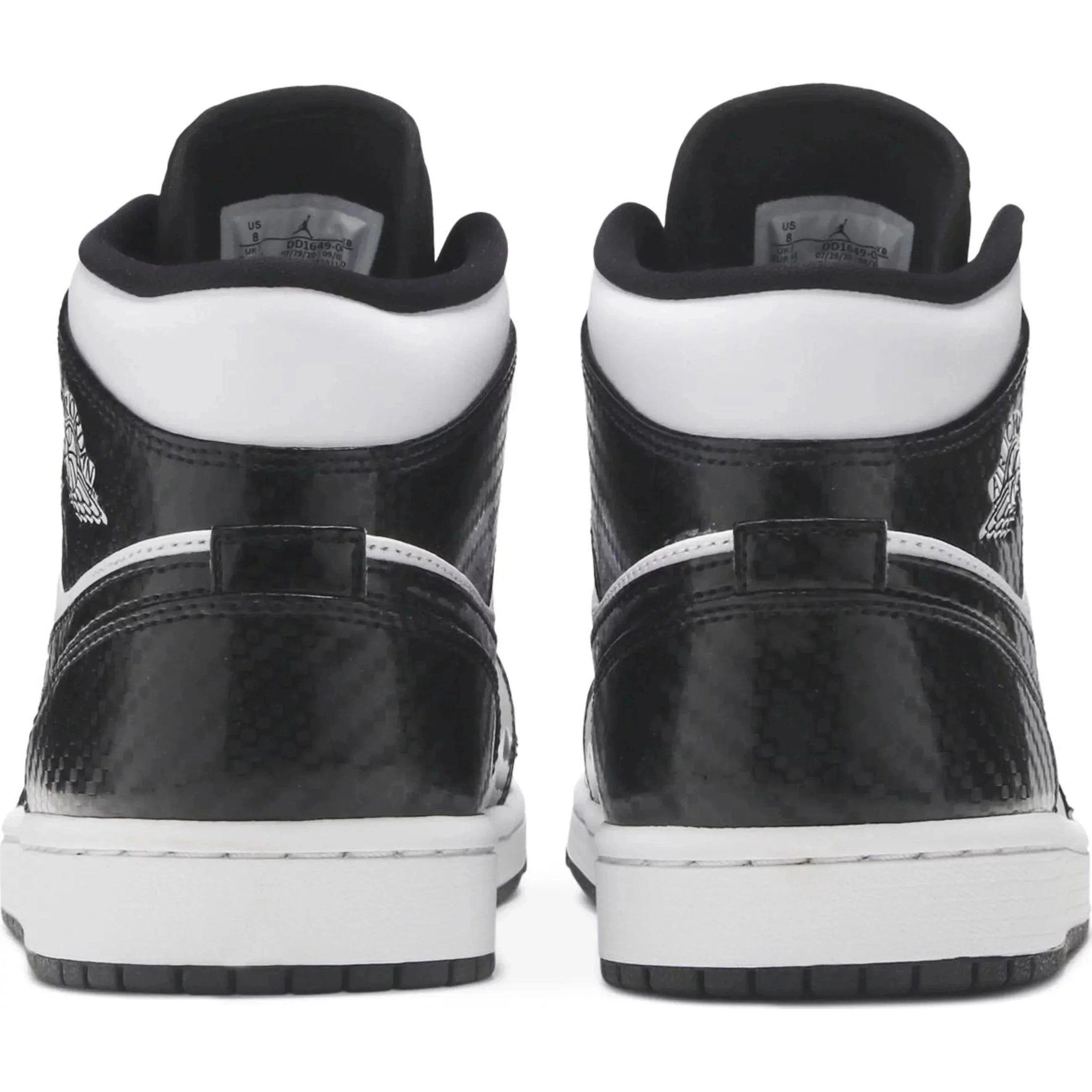 Back view of black and white mid-top sneakers with textured pattern and white soles