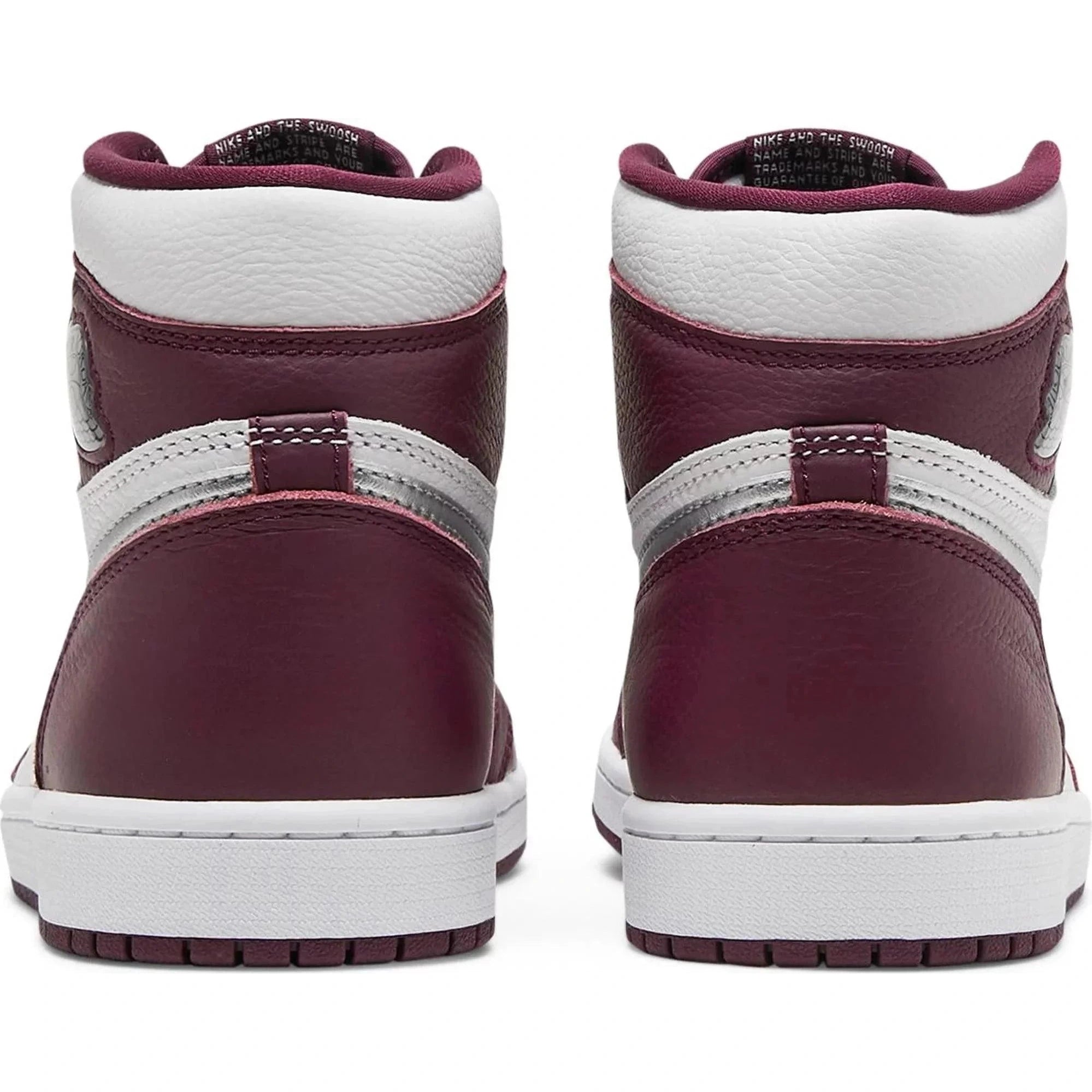 Rear view of maroon and white high-top sneakers with silver accents, streetwear style.