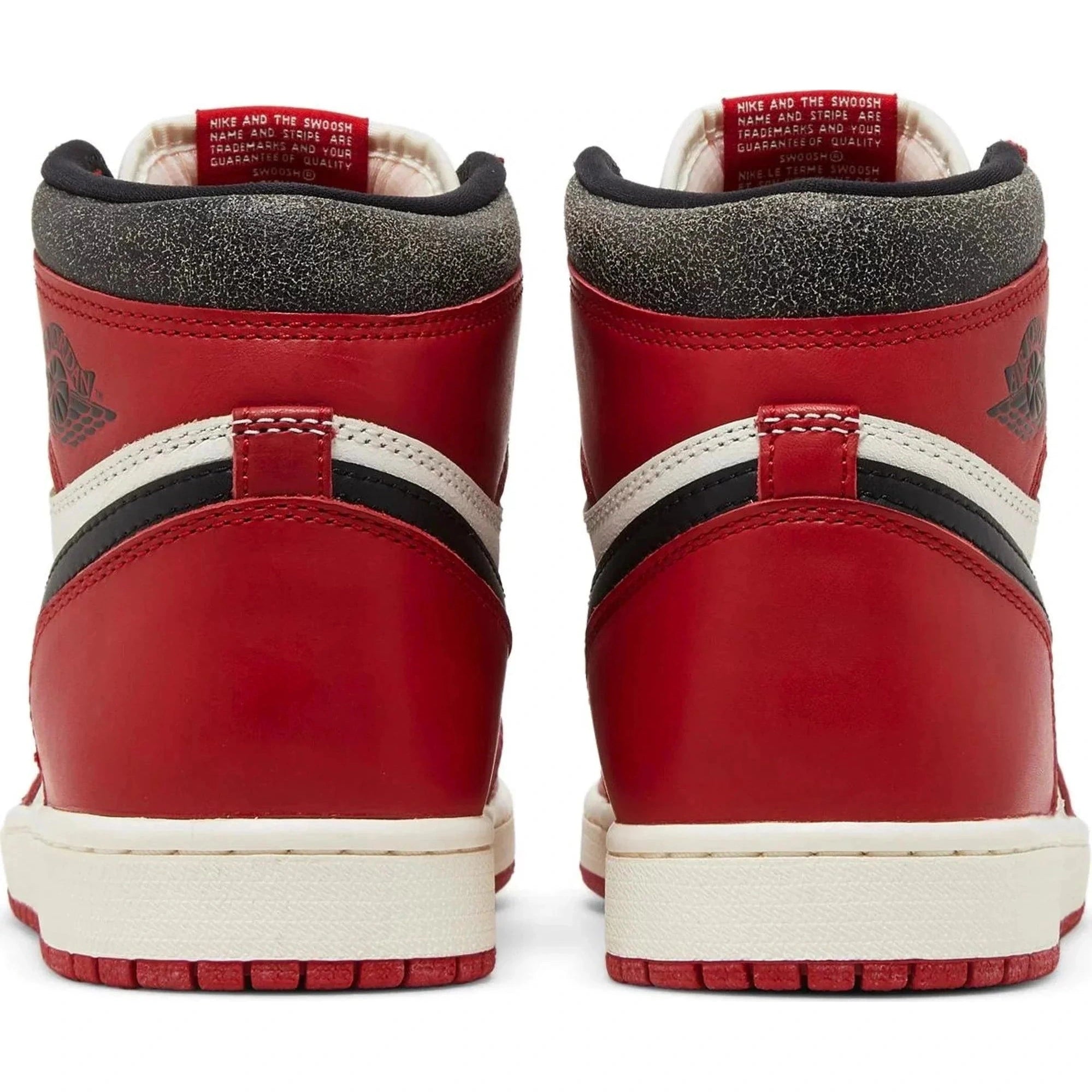 Back view of red, white, and black retro high-top sneakers with vintage finish