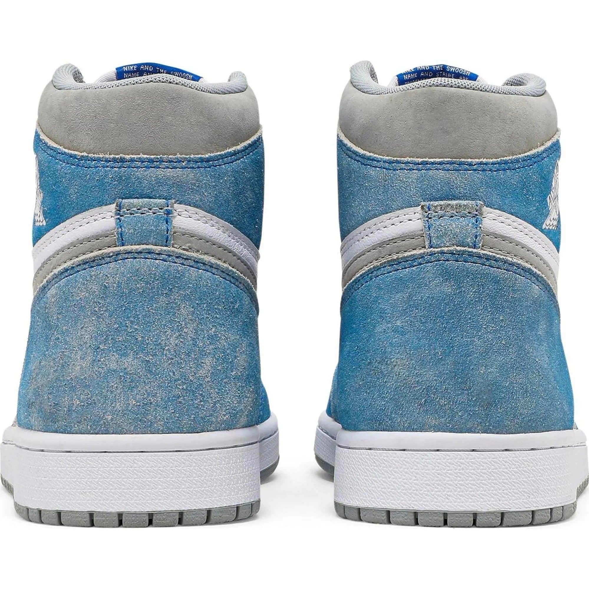 Rear view of blue and grey high-top sneakers with white soles and suede texture.