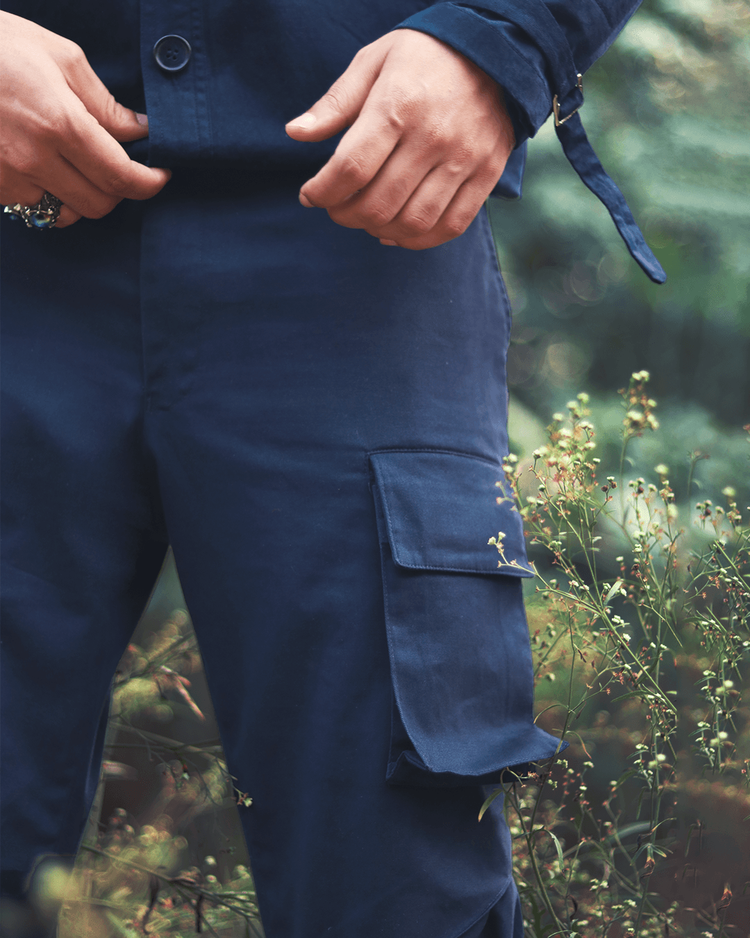 Close-up of blue cargo pants with utility pocket, streetwear style, outdoors