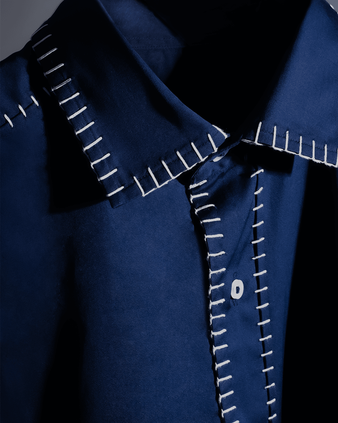 Blue streetwear shirt with white oversized stitching detail on collar and placket