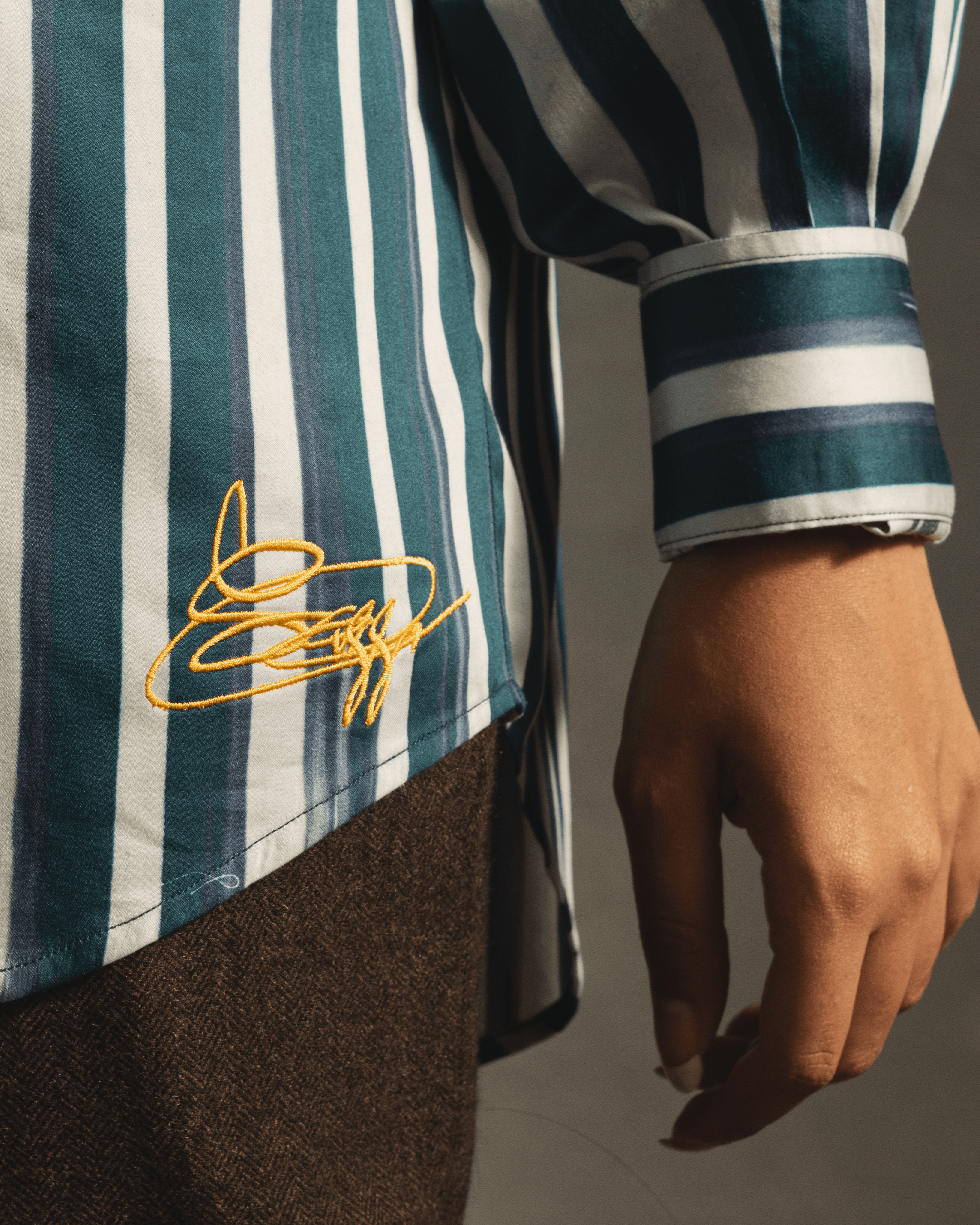 Blue and white vertical striped shirt with yellow embroidered accent, streetwear fashion