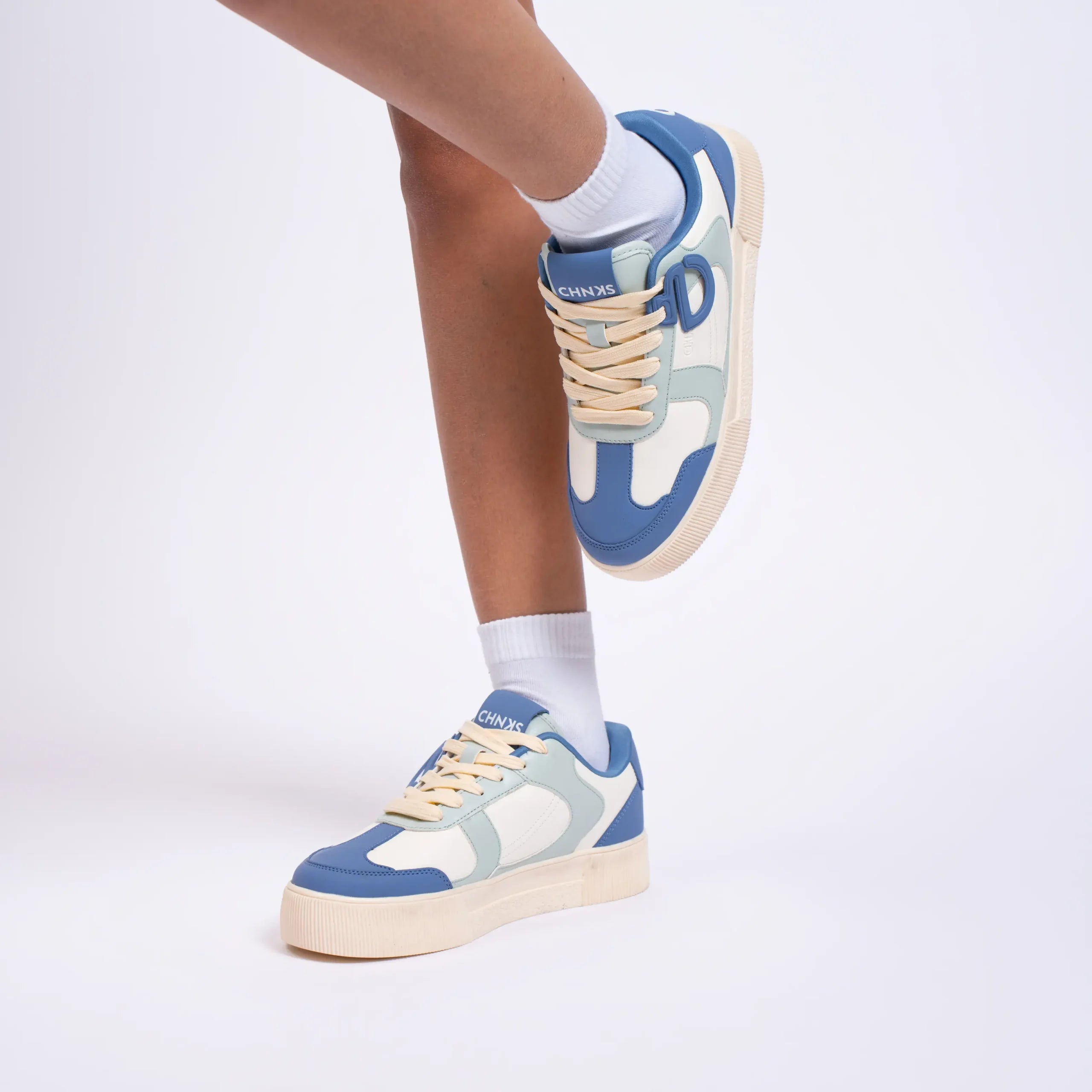 Atlantis CHNKS blue sneakers on women’s feet – casual everyday sneakers for streetwear fashion