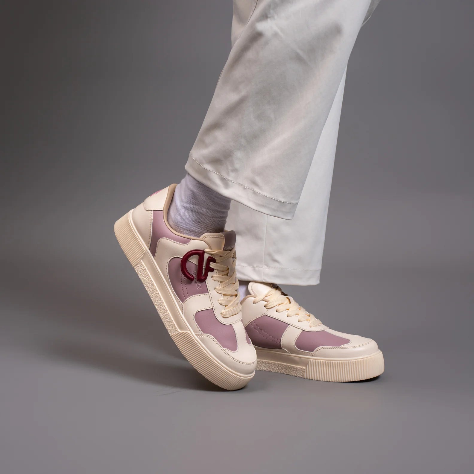 Bubblegum CHNKS pink and white sneakers lifestyle image – casual streetwear style with white trousers
