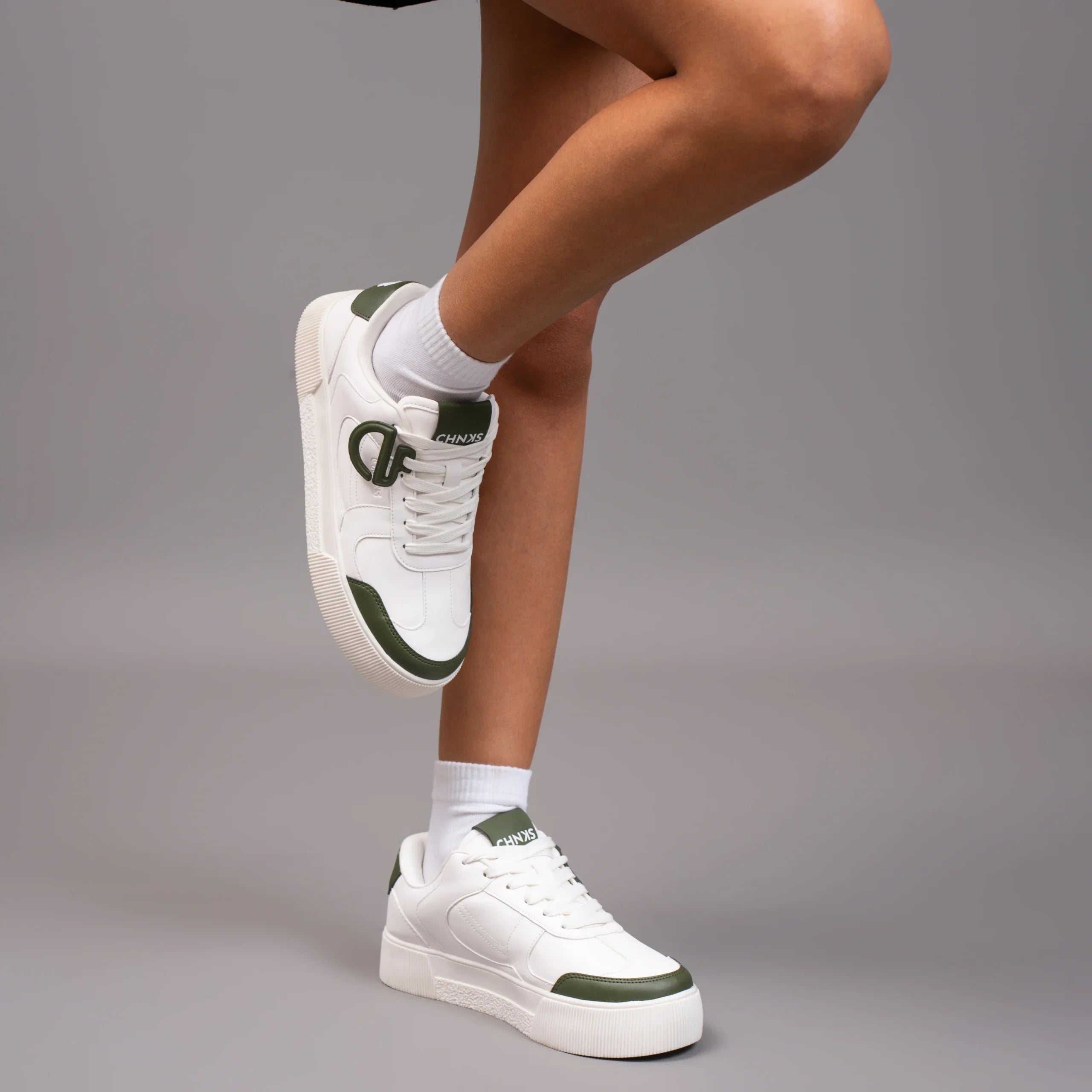 Icy CHNKS sneakers on leg – women’s white and green sneakers for casual outfits
