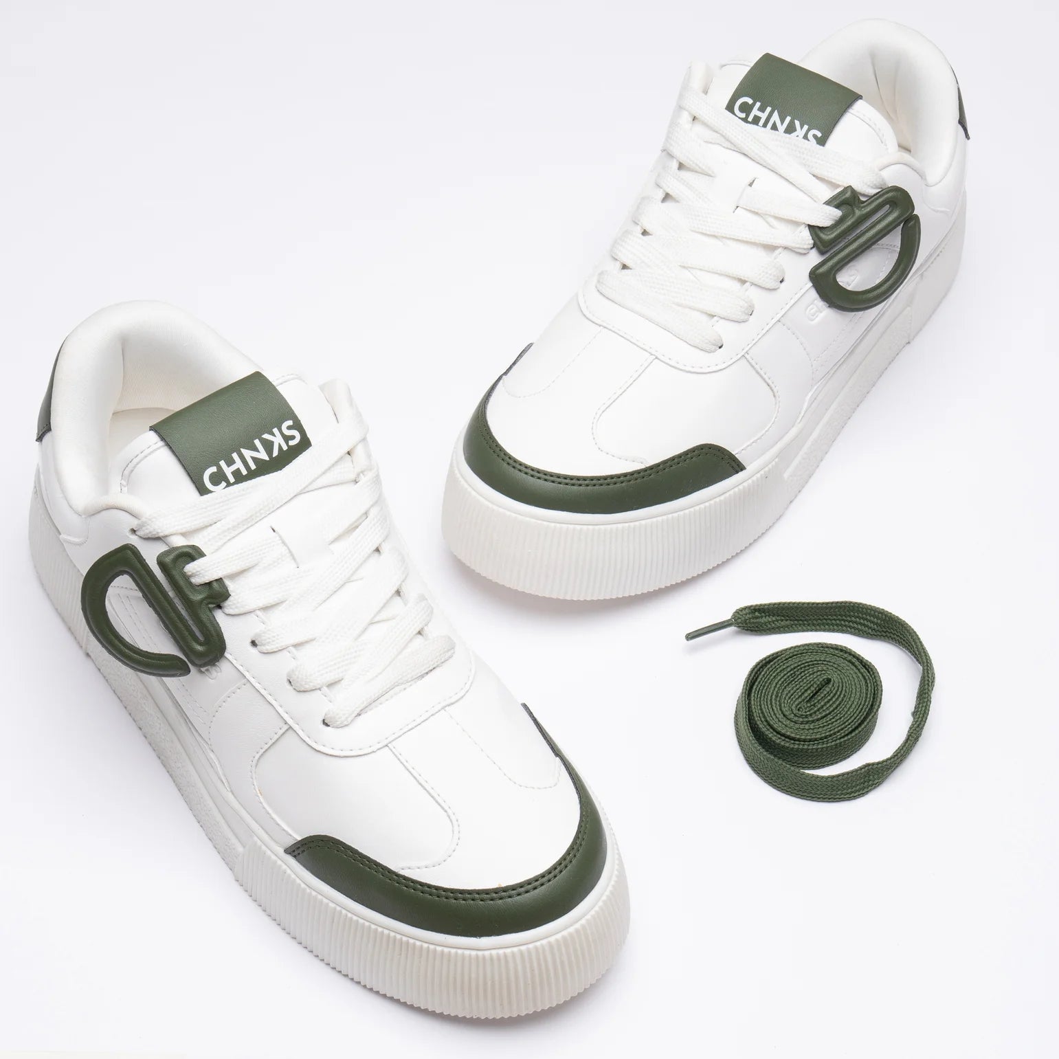 Front view of Icy CHNKS sneakers – minimal white sneakers with green lace accents