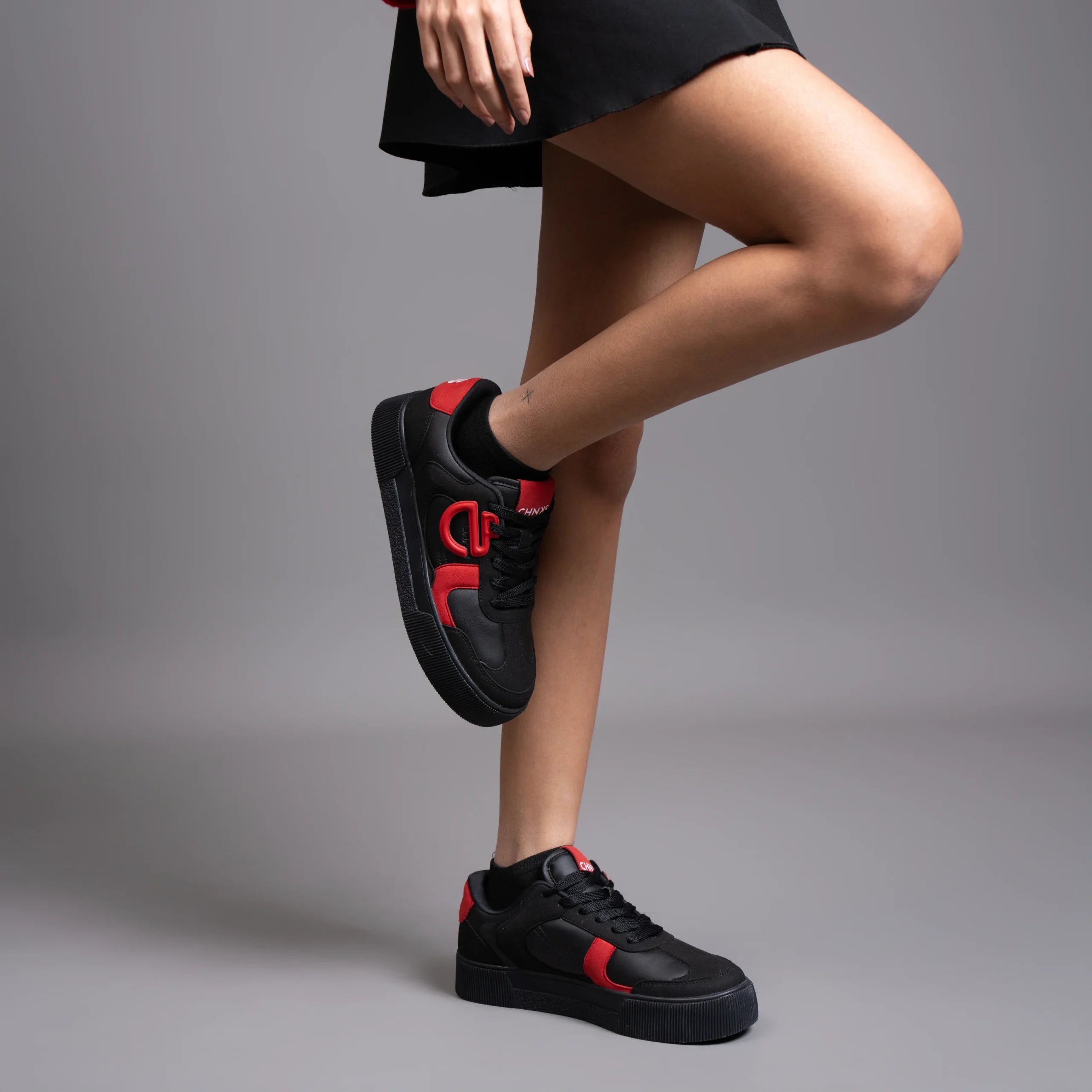 Vinyl CHNKS sneakers on leg – women’s casual street style sneakers