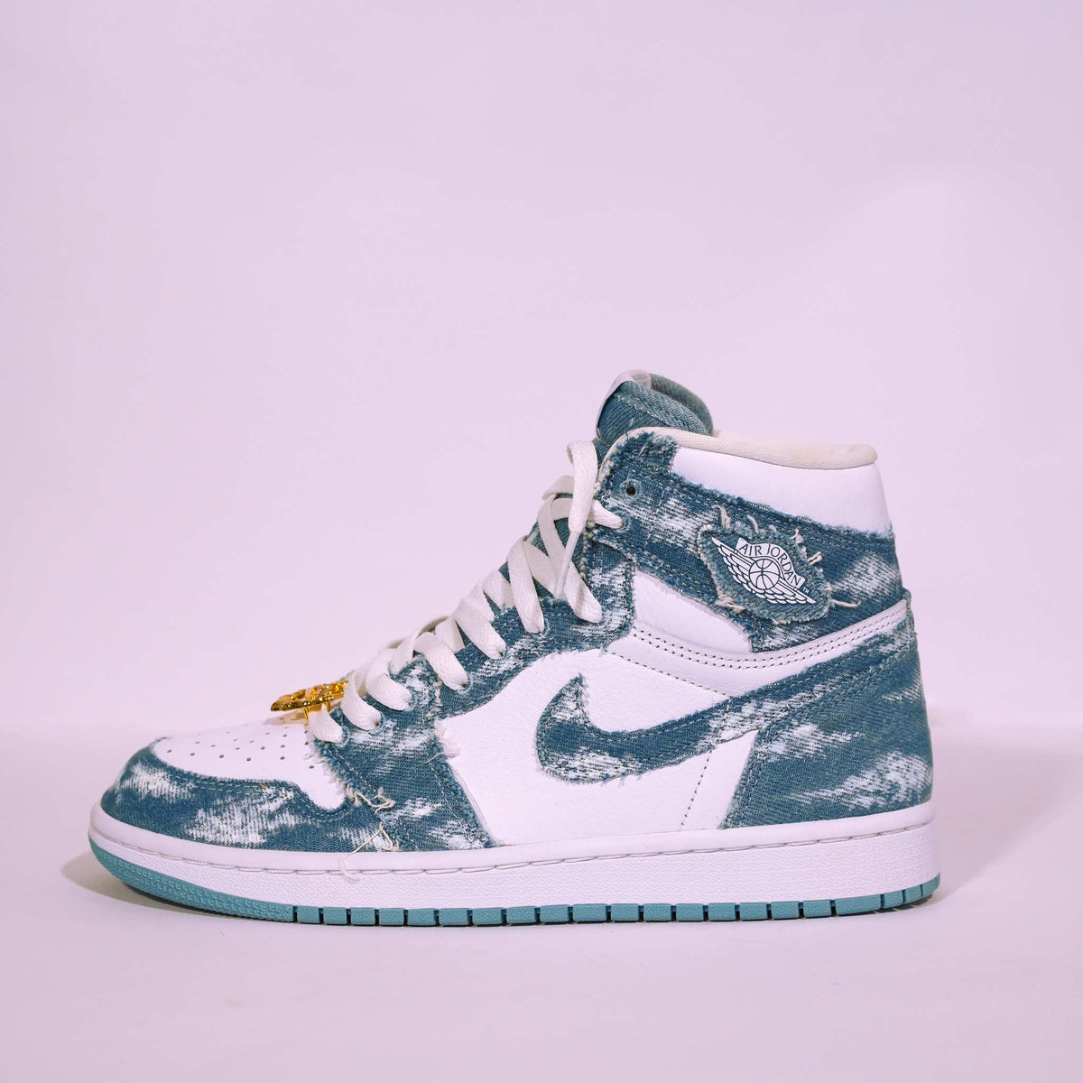High-top white and blue distressed denim sneaker with signature wing logo on side