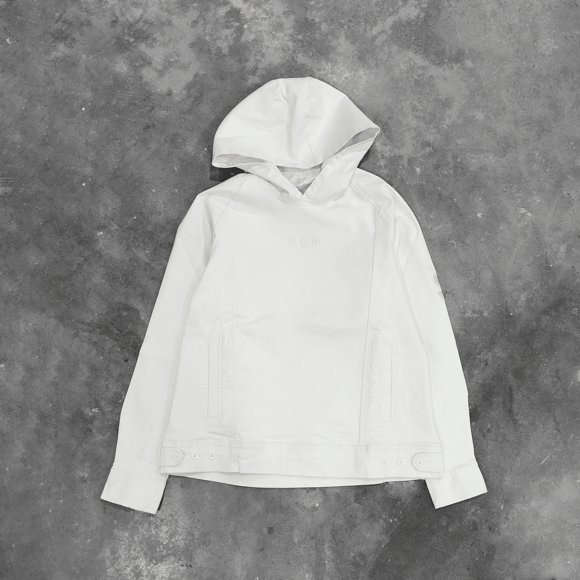 White denim hooded jacket with flat front, displayed on concrete background, streetwear style