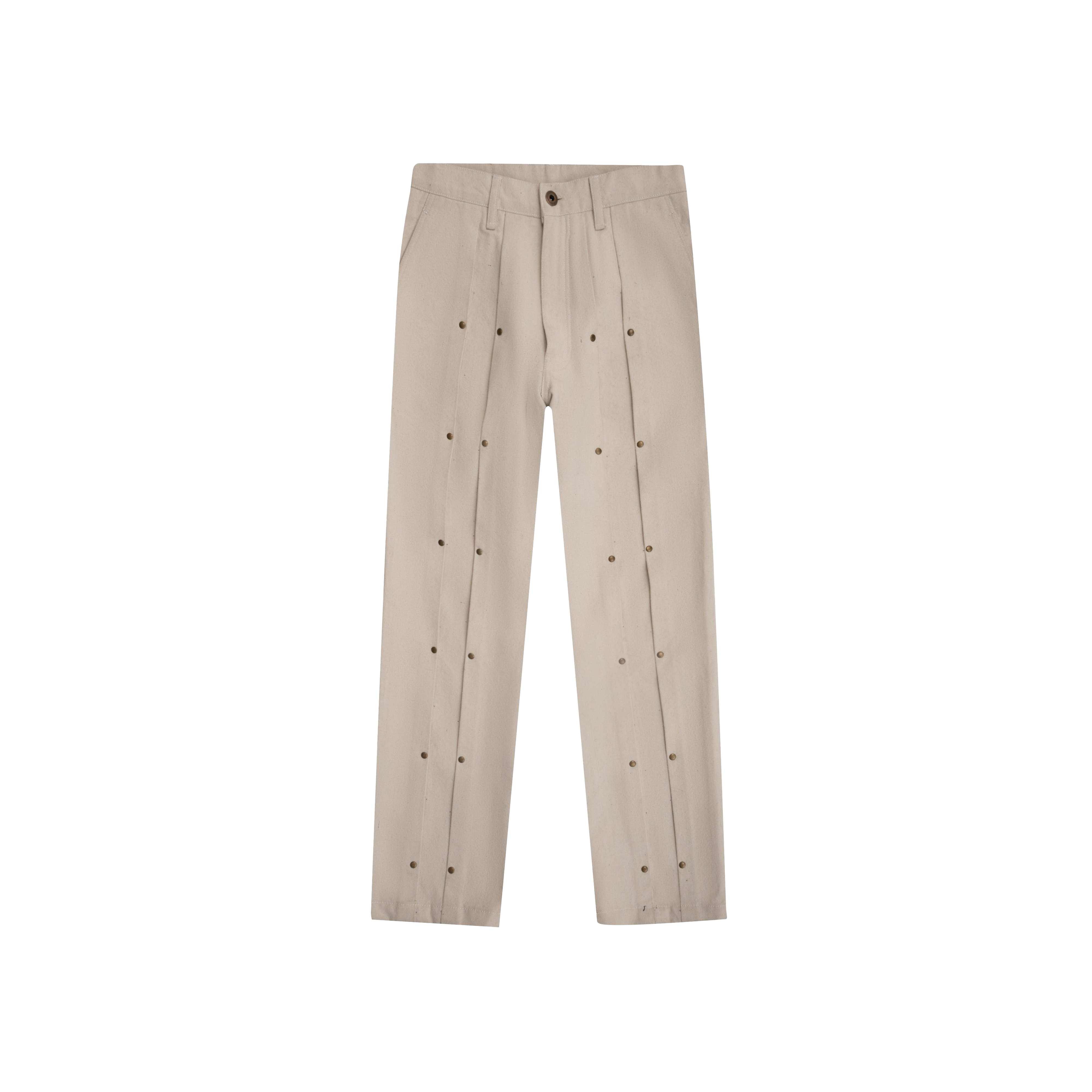 Beige double pleated jeans with front metal eyelet details, laid flat on white background