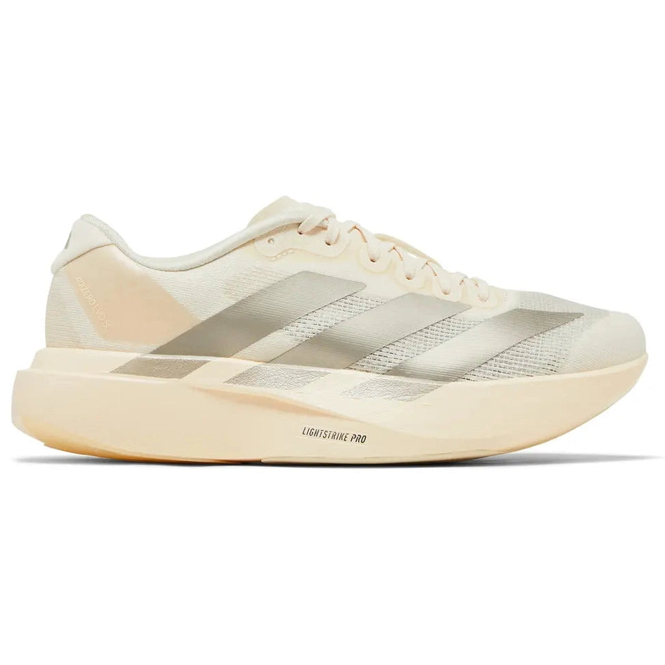 Beige athletic sneaker with mesh upper, translucent stripes, and thick cushioned sole.