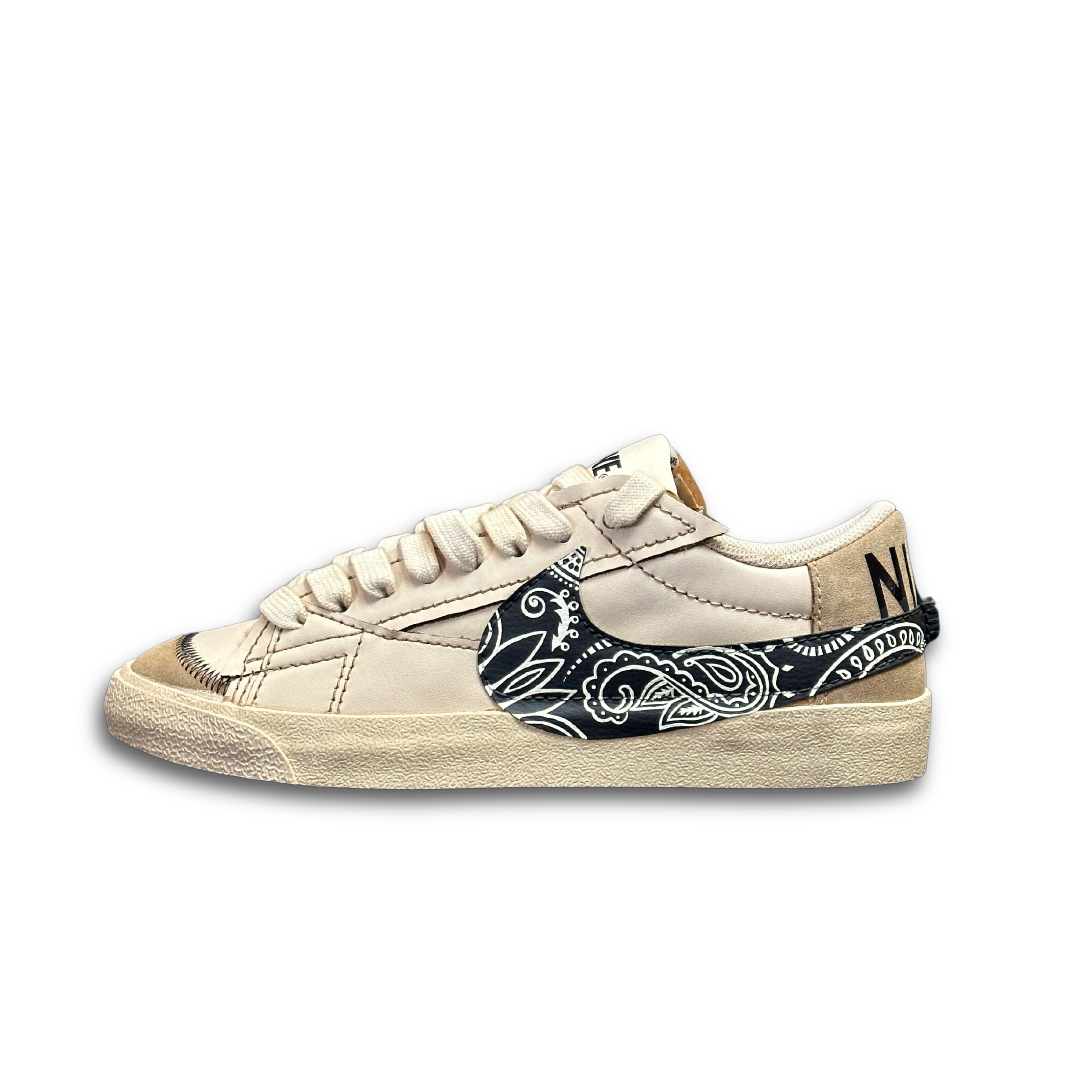 Beige streetwear sneaker with black paisley Swoosh and textured sole, lifestyle footwear