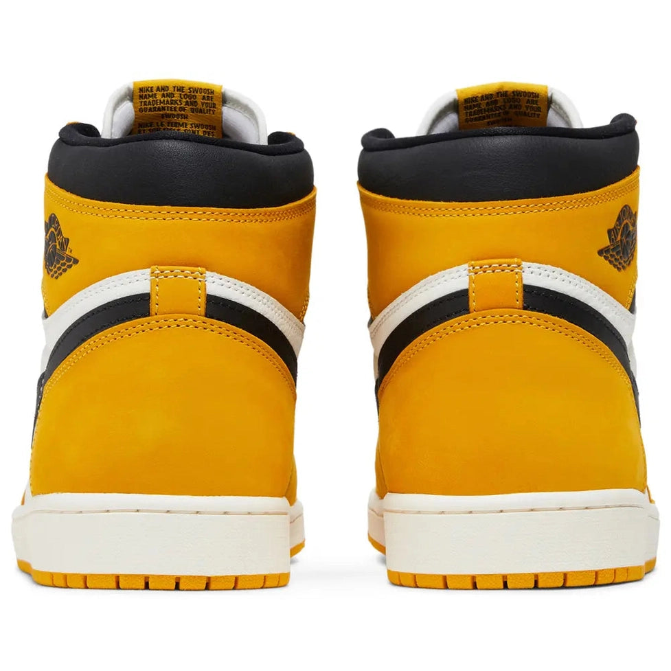 Rear view of yellow high-top sneakers with white and black accents on a white background