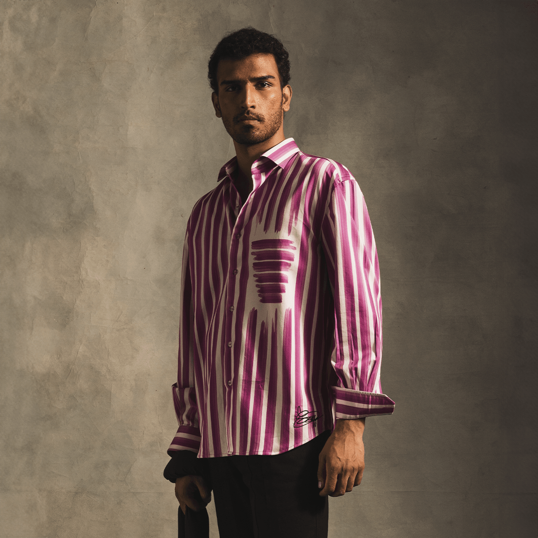 Man wearing a pink and white striped long sleeve shirt, streetwear fashion style