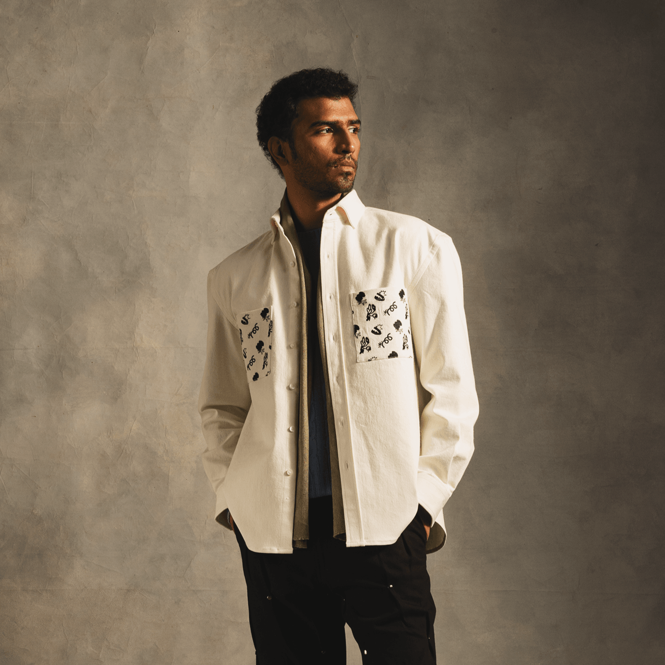 Man wearing off-white streetwear shirt with graphic embroidered chest pockets