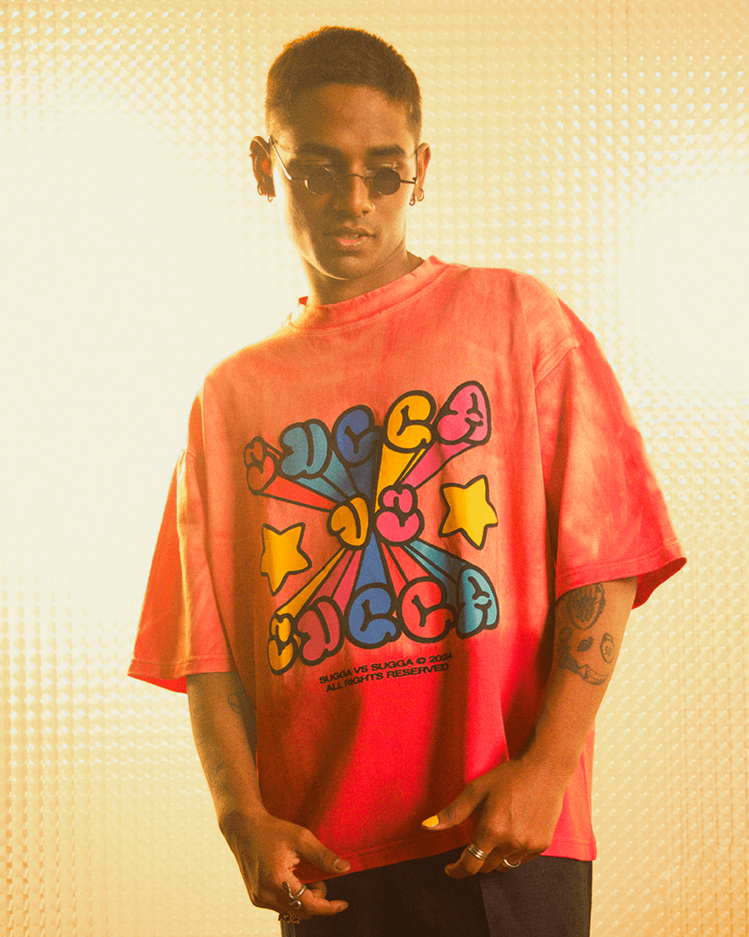 Model in a bold streetwear graphic tee with colorful cartoon lettering and stars, trendy style