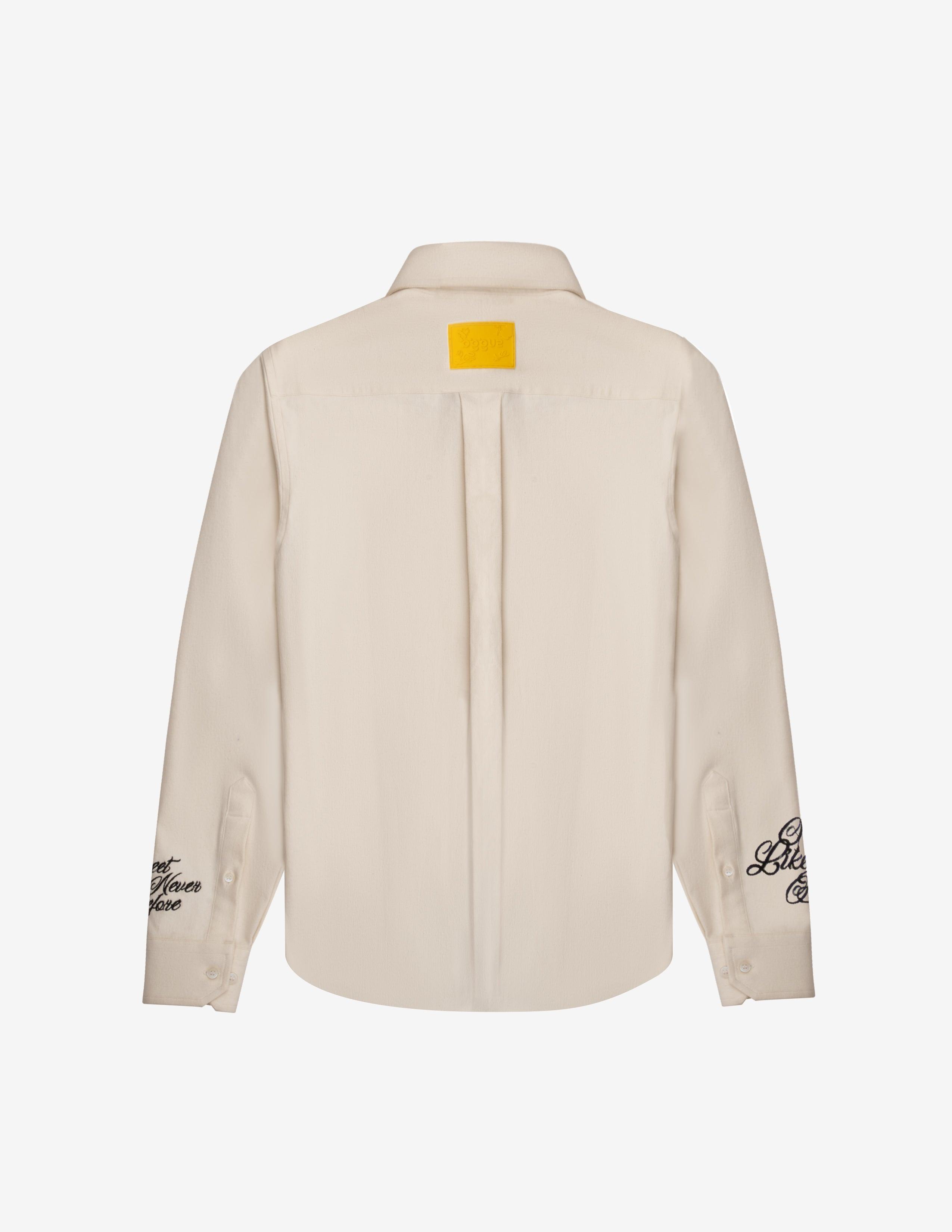 Cream denim overshirt back view with yellow patch and black embroidered sleeve text