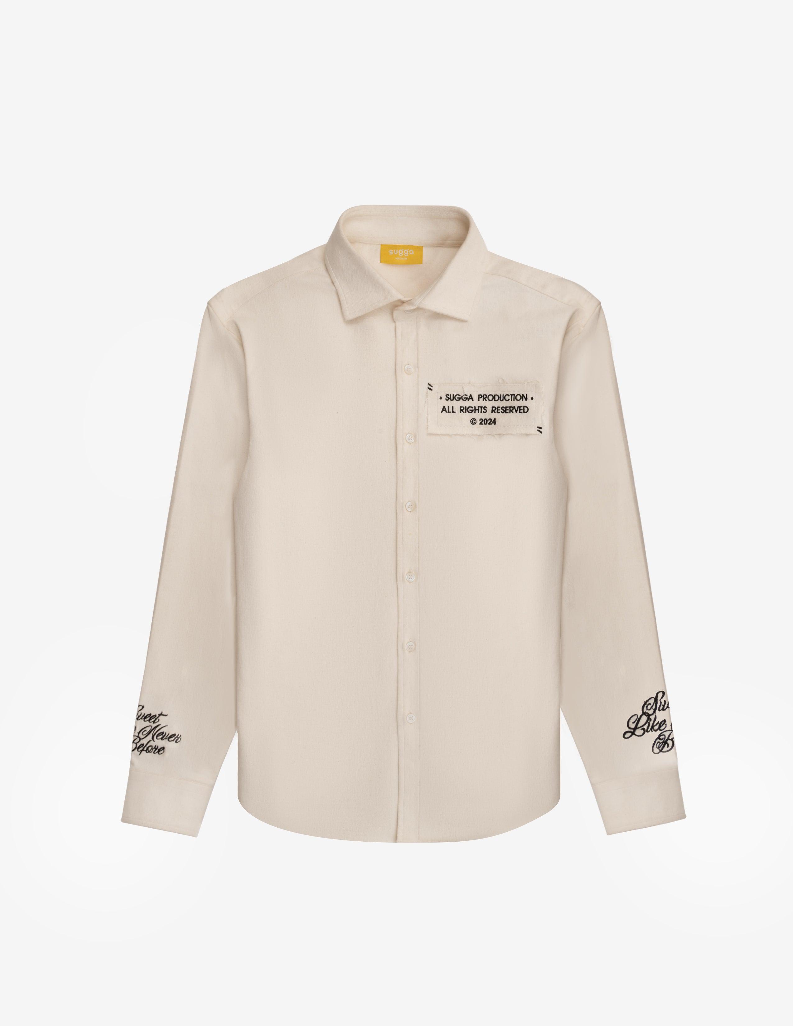 Cream denim overshirt with black embroidered text on chest and sleeves, streetwear style