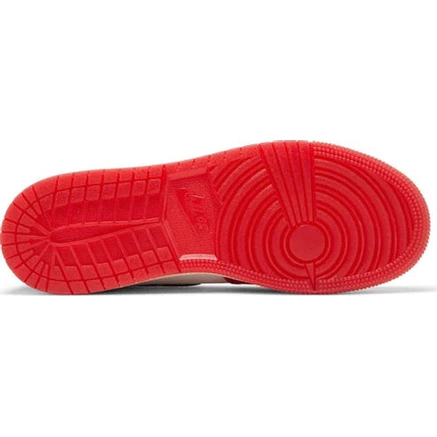Red rubber outsole of a high-top streetwear sneaker with textured grip pattern