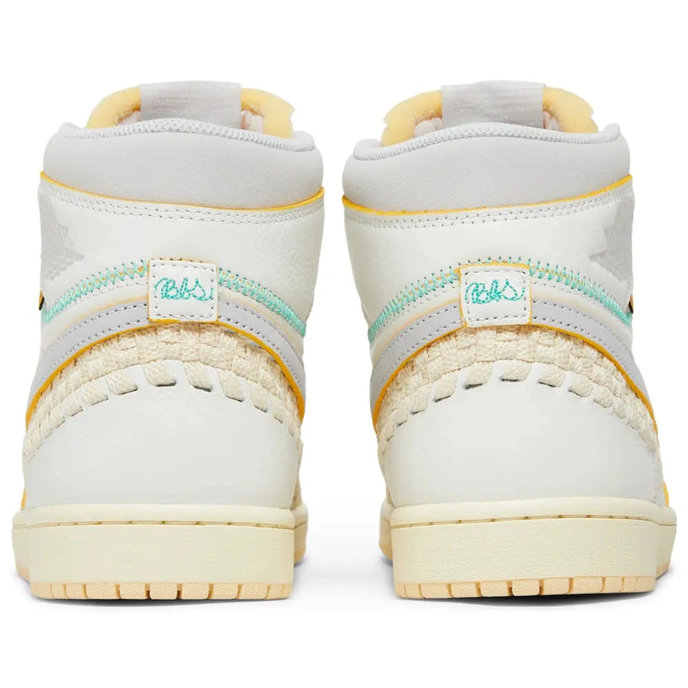 Rear view of white and beige high-top sneakers with yellow and teal stitching accents