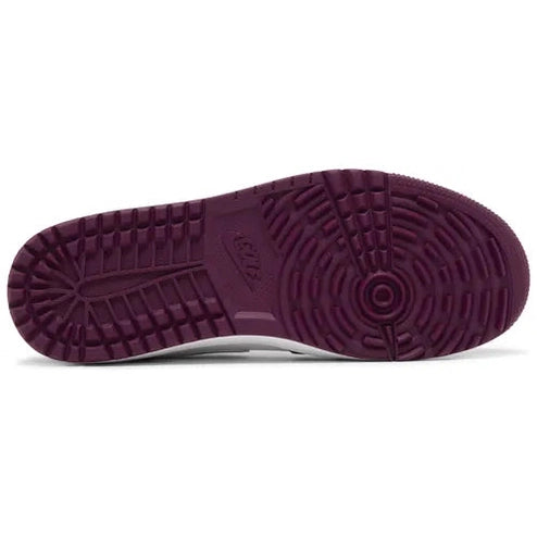 Burgundy outsole of a designer sneaker with detailed tread pattern, streetwear shoe