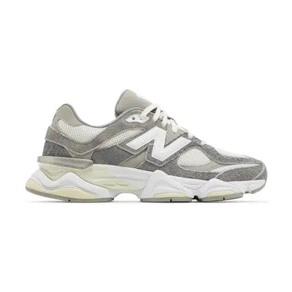 Gray and white New Balance sneaker with mesh and suede overlay, side view