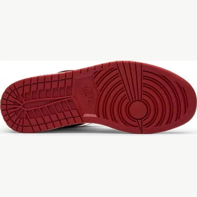 Red rubber sole of a streetwear sneaker with circular tread pattern and Nike logo visible