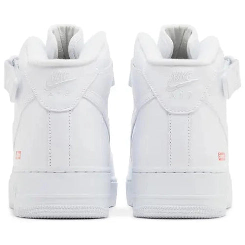Back view of white Nike Air Force 1 sneakers with visible Air logo and ankle strap