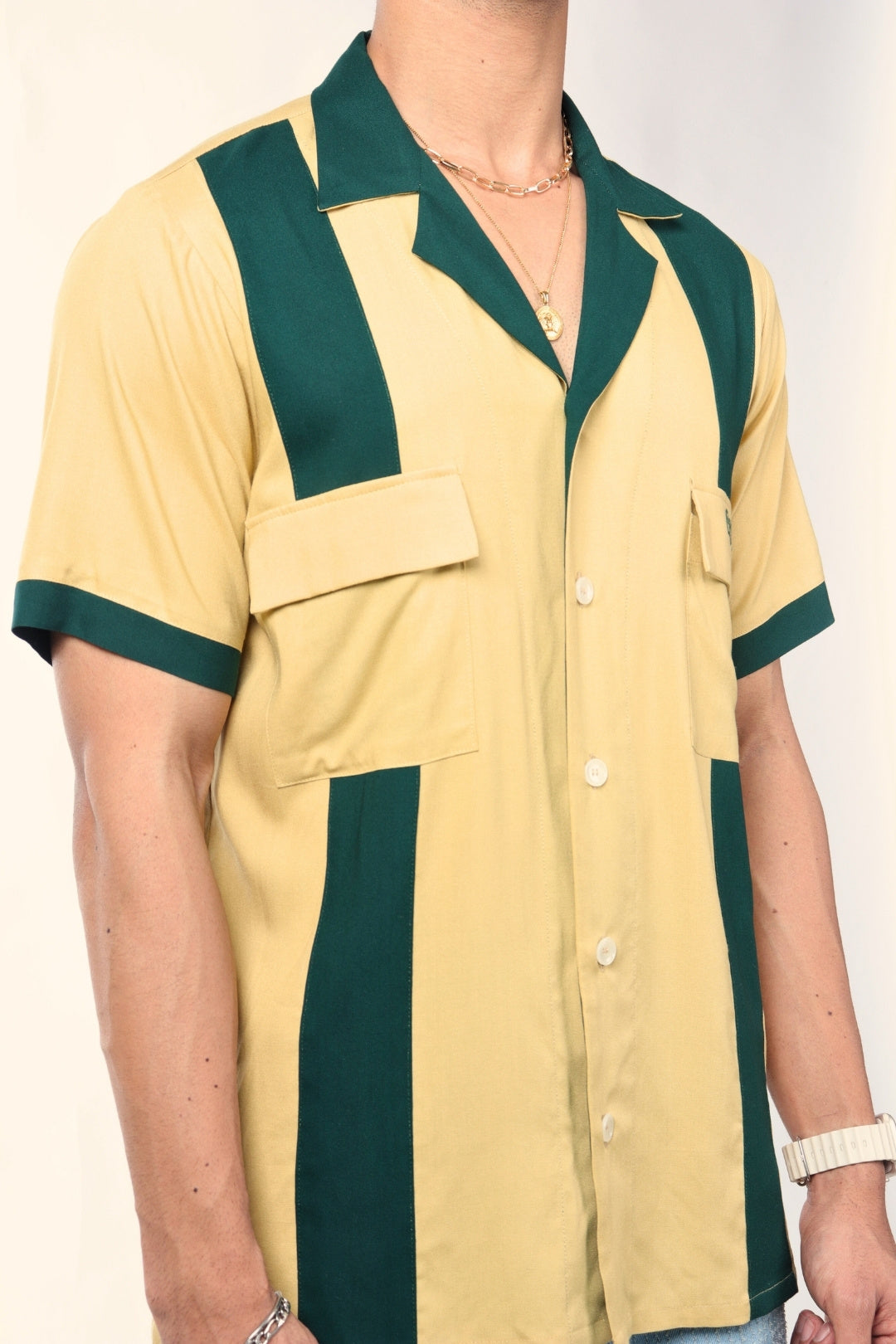Short sleeve beige and green vertical stripe button-up shirt with chest pockets