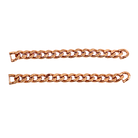 Two gold Cuban link sneaker chains laid out on a plain background.