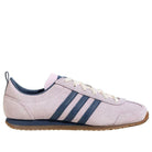 Light purple sneaker with three blue stripes on a white background