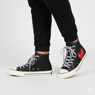 Black high-top sneakers with colorful Gradient laces and a red heart design on a white background