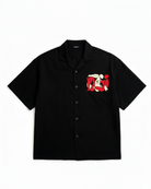 Black shirt with a graphic design on the chest against a white background