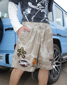 Man standing beside a blue car wearing Fearless Under Everything Mad-Max Shorts with streetwear styling.