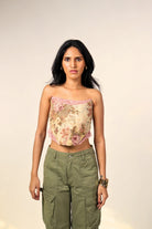 Woman in a floral crop top with lace trim and olive cargo pants, streetwear fashion
