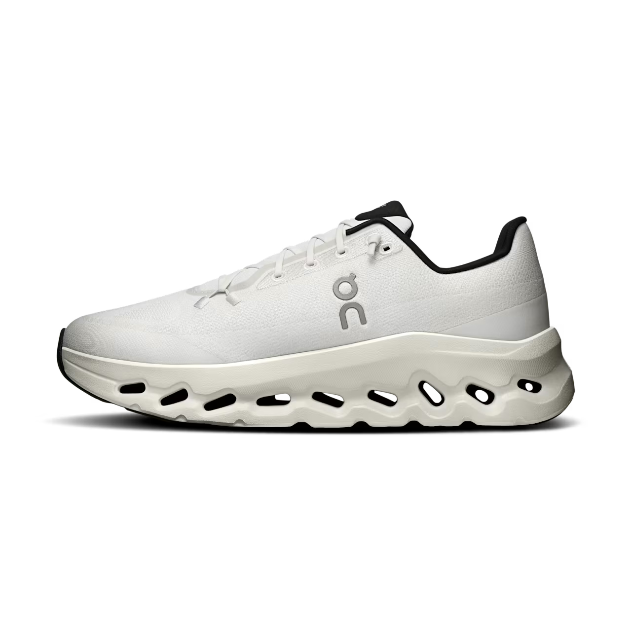 White designer sneaker with perforated chunky sole and black accents, side profile view.