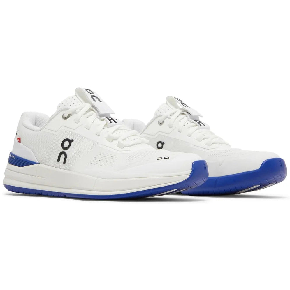 White mesh sneakers with blue sole and black logo, modern streetwear athletic footwear