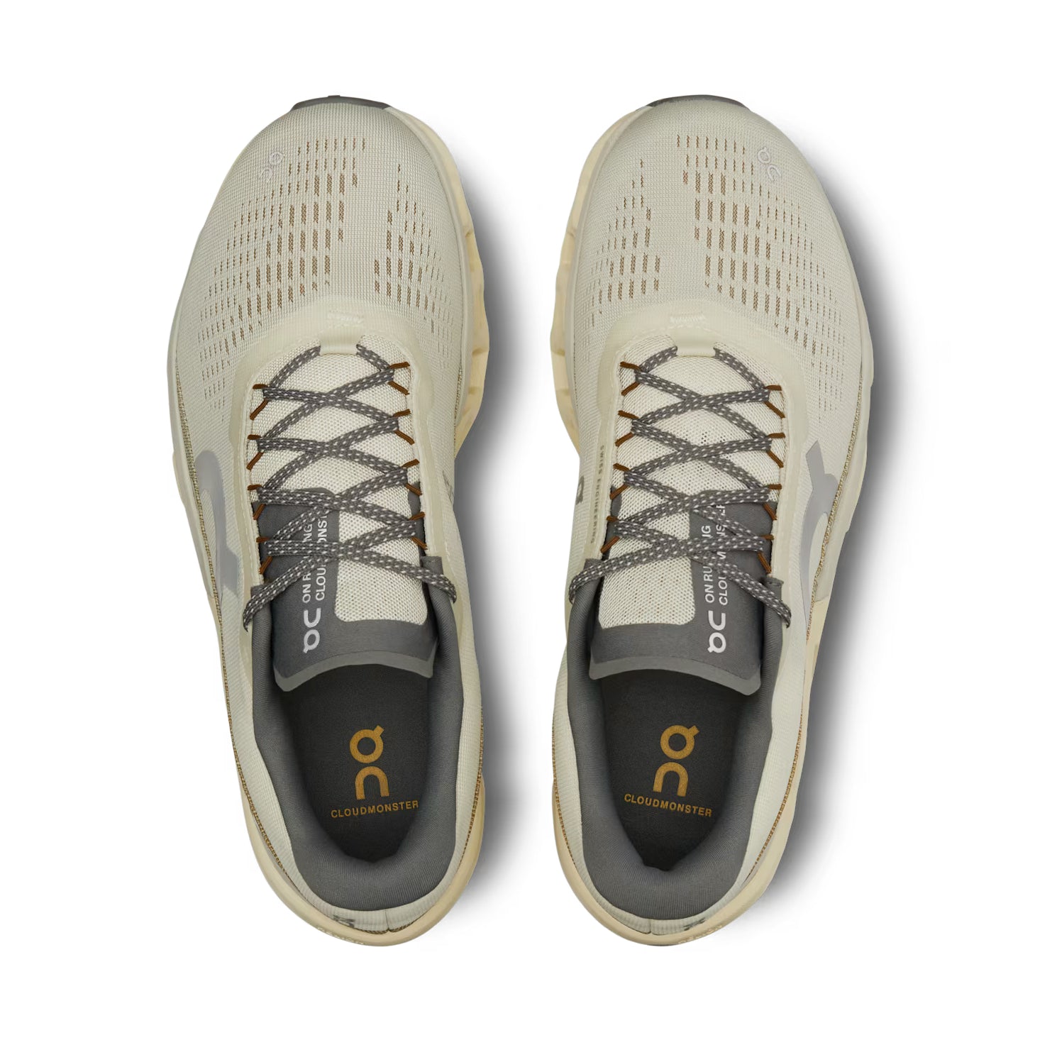 Top view of beige On Cloudmonster sneakers with mesh upper and grey laces