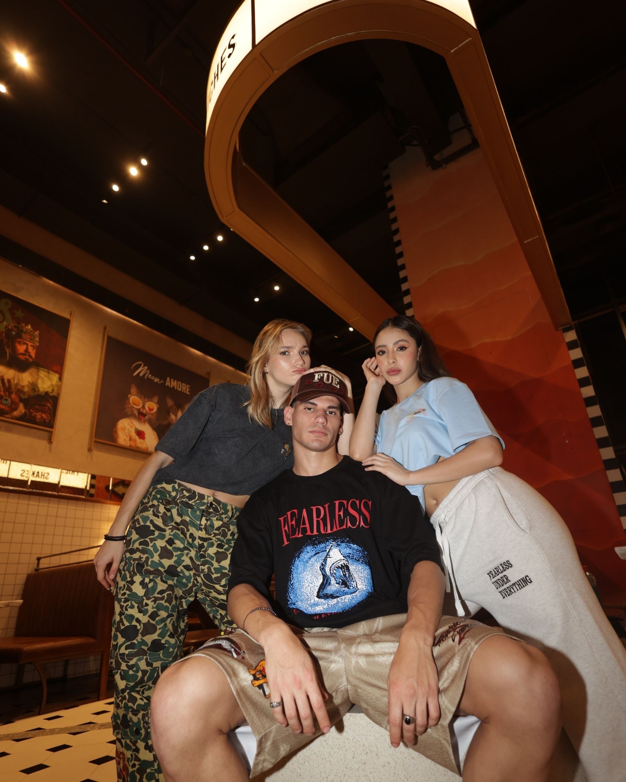 Group of people in Fearless Under Everything apparel including Mad-Max Shorts posing indoors.