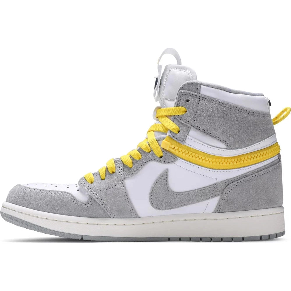 High-top sneaker with grey suede, white leather, yellow laces, and zipper detail, side view