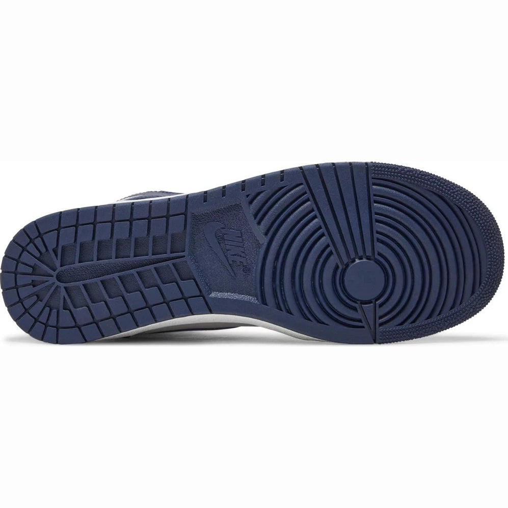 Navy blue rubber sole of a sneaker with textured traction pattern, viewed from below