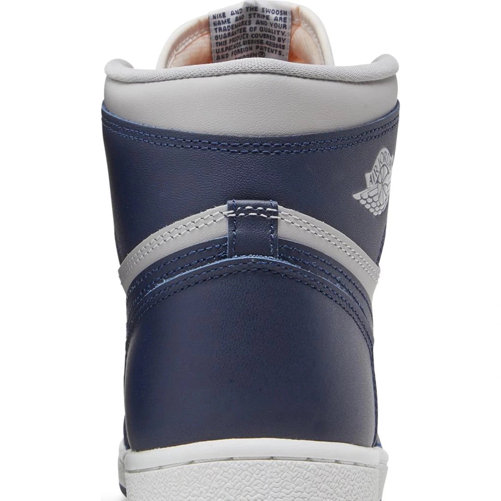 Rear view of a high-top navy and white leather sneaker with stitched details and embossed logo