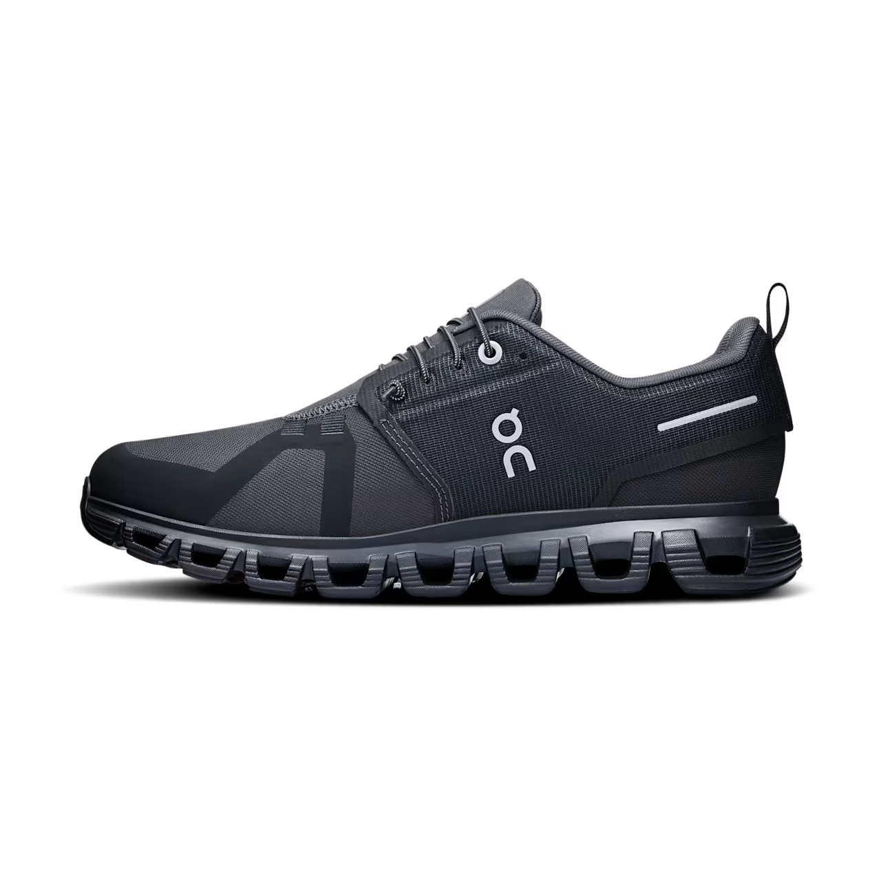 Black designer sneaker with mesh upper, white logo, and cushioned sole on black background